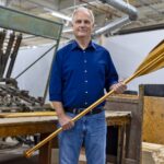 W. Graeme Roustan with a new Grey Owl paddle at the Roustan Sports factory